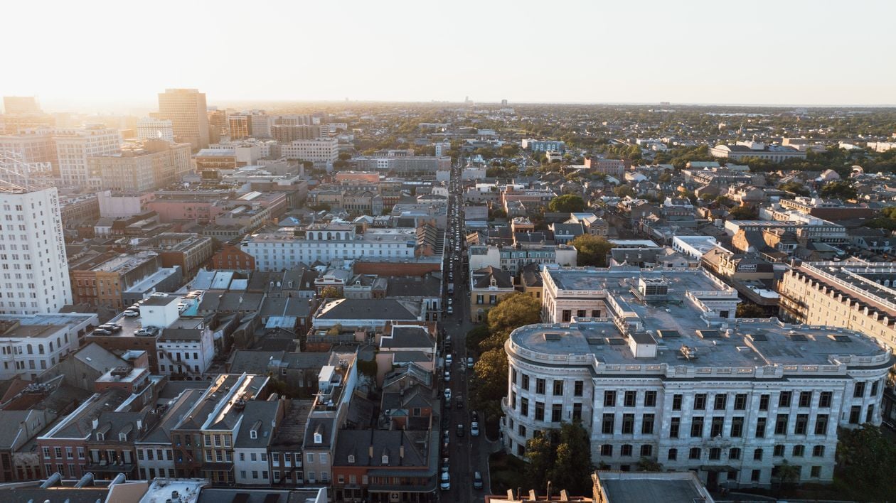 Golden-hour aerial view over French Quarter rooftops in New Orleans